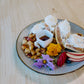 Plated waffles dressed with marigold and berries