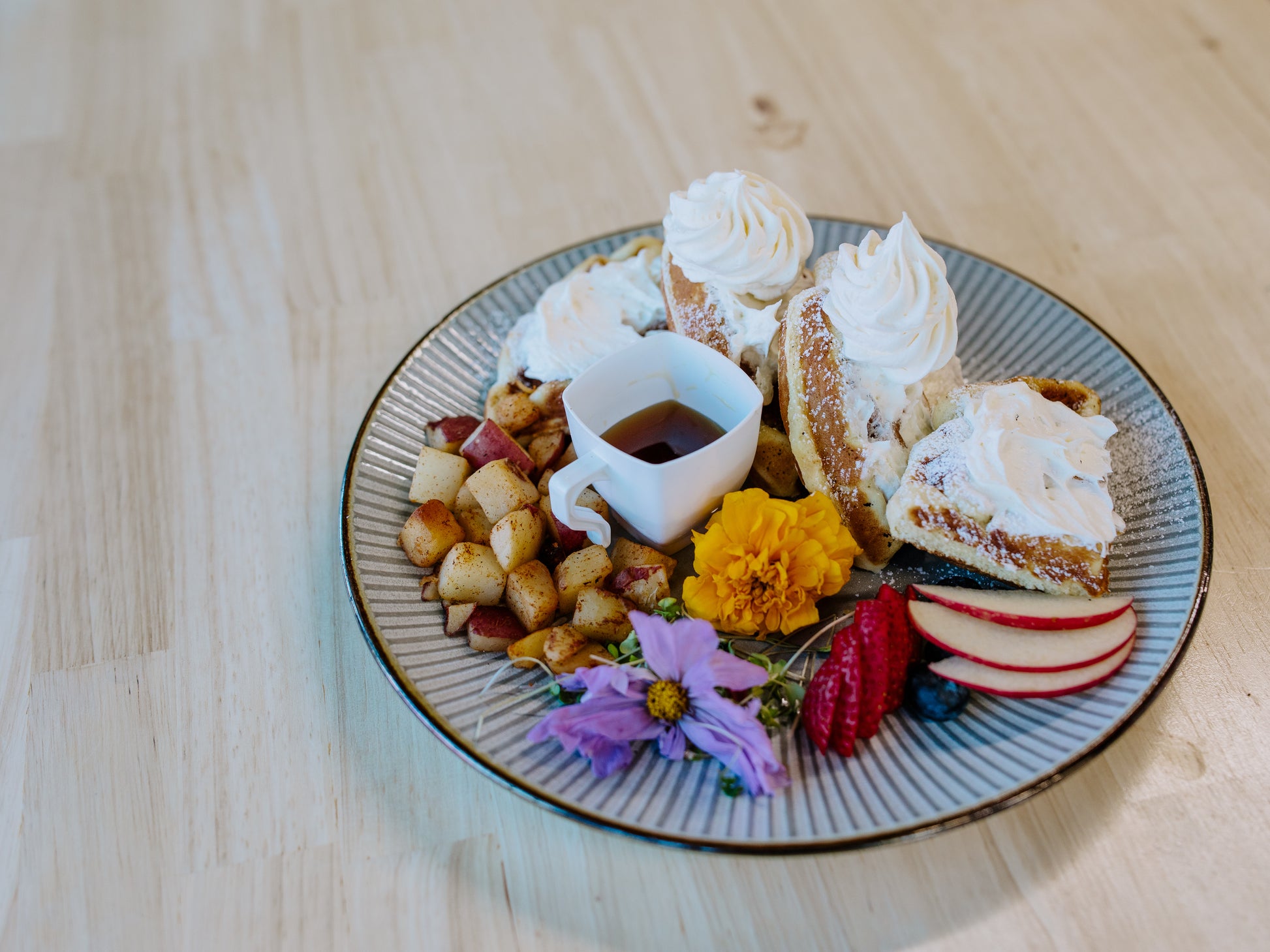 Plated waffles dressed with marigold and berries